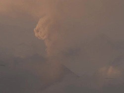 Volcano erupts mushroom cloud ash explosion into the sky, Philippines, Dec 2009 Stock Footage