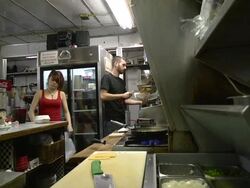 MS ZI Cook making to go order of chili cheese fries at classic American diner / Ann Arbor, Michigan, United States Stock Footage