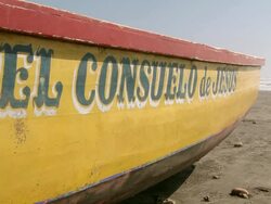 CU Shot of words El Consuelo de Jesus painted on side of small yellow boat / Pimentel, Lambayeque, Peru Stock Footage