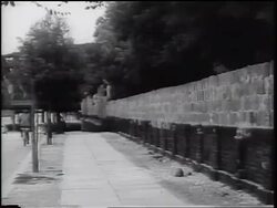 B/W 1961 Berlin Wall under construction next to sidewalk / West Berlin / Cold War / Germany Stock Footage