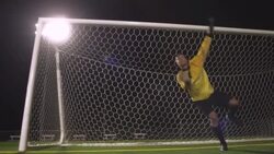 A goaltender dives to save the soccer ball from going into the net. Stock Footage