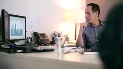 Boss leads meeting with businesswomen in private corporate office, directs attention to bar-graph Stock Footage