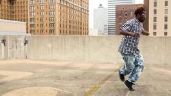 MS Man doing backflip on rooftop of building Stock Footage