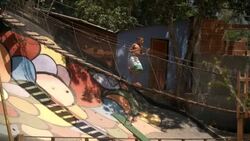 Friends watch as boy runs across swinging rope bridge Stock Footage