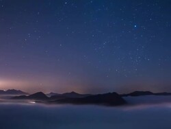 View of star trail in the sky and flowing cloud sea Stock Footage