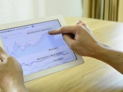 Man playing tablet with stock graph Stock Footage