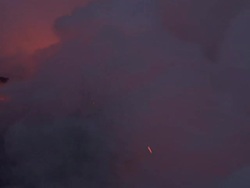 Medium Long Shot static - Smoke blows across flowing lava from a volcano on Hawaii's Big Island. / Hawaii, USA Stock Footage