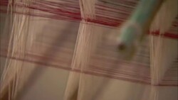 Silk threads criss cross over a loom. Stock Footage