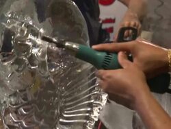 An artist uses a tool to carve details into an ice sculpture. Stock Footage