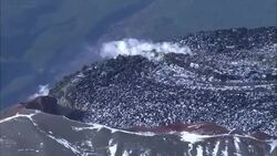 A volcanic crater releases smoke. Stock Footage