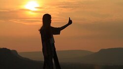 silhouette of women selfie with mountain at sunset . Stock Footage