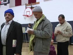 November 2, 2010 PAN Girl wanders around Arab voters standing in line / Dearborn, Michigan, United States Stock Footage