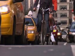 Cyclists and pedestrians weave through vehicles stopped in traffic. Stock Footage