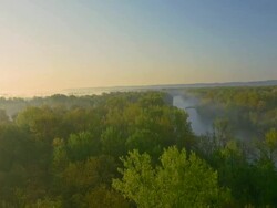 AERIAL Green forest surrounding the Mur river Stock Footage