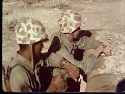1950s MS Two soldiers standing in trench / man checking his watch at Camp Desert Rock at Nevada Test Site / Nye County, Nevada, USA Stock Footage