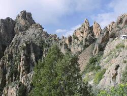 WS A camper on the road through the fantastic rock landscape of the Calanche of Piana, UNESCO World Heritage Site / Gulf of Porto, Corsica, France Stock Footage