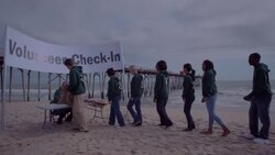 Volunteers line up for check in Stock Footage