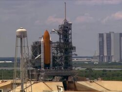 Aerial space shuttle on launching pad with Vehicle Assembly Building visiible in background / John F. Kennedy Space Center, Cape Canaveral, Florida Stock Footage