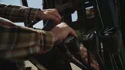 Masculine hands operate the steering wheel and controls of a forklift. Stock Footage