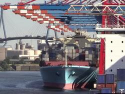 MS Shot of unloading containers in container ship on container terminal with Kohlbrand Bridge in harbour / Hamburg, Germany Stock Footage