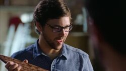 Wood shop craftsman teaches new worker about skateboard design Stock Footage