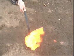 Man lighting flamable paste in crucible and pouring burning, molten liquid to floor, Forge, UK (sound available) Stock Footage