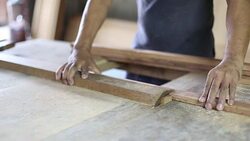 Carpenter at workshop using saw machine on wood work Stock Footage