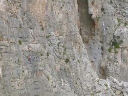 WS ZI ZO AERIAL View of caves with climbers climbing on cliff / Kalymnos, Cyclades, Greece Stock Footage
