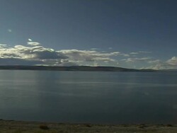 Pan Right sun shining on Mansarovar Lake Lhasa Tibet China Stock Footage