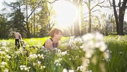 SLO MO Woman reading a book in the park Stock Footage