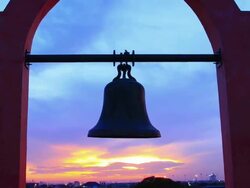 Ancient Bell against colorful sunset Stock Footage