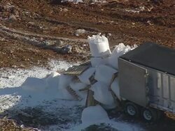 CU AERIAL Shot of truck unloading boxes at Landfill (outside Fairmont Mill) / South Carolina, United States Stock Footage