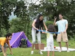 Family playing with hula hoop in a forest, Malshej Ghat, Maharashtra, India Stock Footage