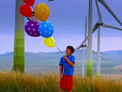 Boy in Field of Wind Turbines Stock Footage