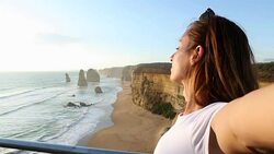 Young woman arms outstretches at the Twelve Apostles-Australia Stock Footage