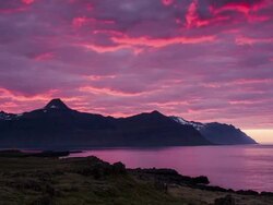 Timelapse of sunset light hitting clouds next to the ocean in Eastern Iceland during midnight sun. Stock Footage