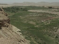 A mixture of green and dusty Moroccan landscape stretches to the horizon. Stock Footage