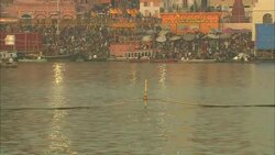 Ropes mark a boundary in the Ganges as the faithful bathe in the river or wait for their turn. Stock Footage