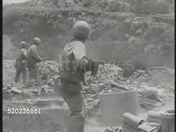 1945: OKINAWA, JAPAN: WS US Marines running across top of hill. Marine firing into trenches. Flamethrower burning vegetation. Hillside US Soldier throwing grenade, explosion other side of hill. Another grenade lob, soldier flinching.  WWII, Pacific Instructional Video