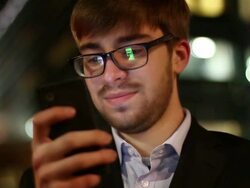 Man glasses text reflections, city night. Stock Footage
