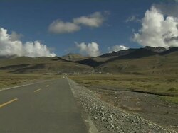 Pan Left Shot Darchen Highway and mountains Lhasa Tibet China Stock Footage