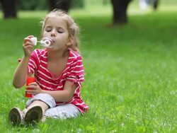 Little girl blowing soap bubbles Stock Footage