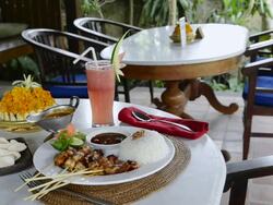 MS Dish of chicken Sate, fried Chicken skewer with steamed rice, kerupuk crackers, watermelon juice and balinese food at Asia / Ubud, Bali, Indonesia Stock Footage