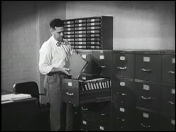 Man opens filing cabinet; inspects files Stock Footage
