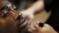 Barber trims customer's beard and moustache with electric clippers in neighborhood barbershop Stock Footage