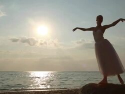 Ballerina by the sea at sunset Stock Footage