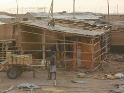 Man working on the roof of a house and man by the side of horse carriage Stock Footage