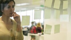 Middle Eastern businesswoman writing notes for the new project Stock Footage