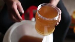 Beekeeper pack honey to small bottles Stock Footage