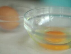 CU Shot of woman cracking two eggs into bowl then hand whisking with fork / Auckland, New Zealand Stock Footage